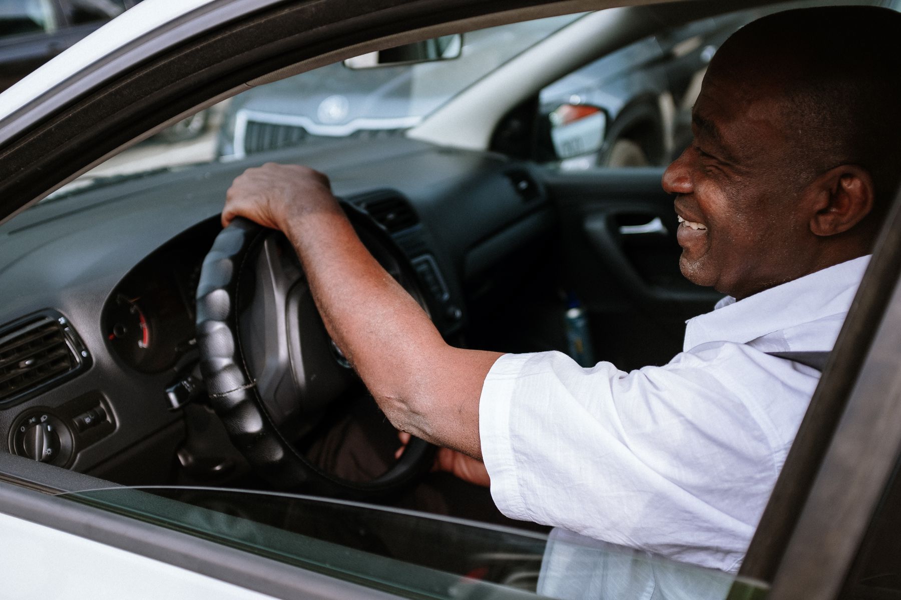 Professional driver smiling from a car